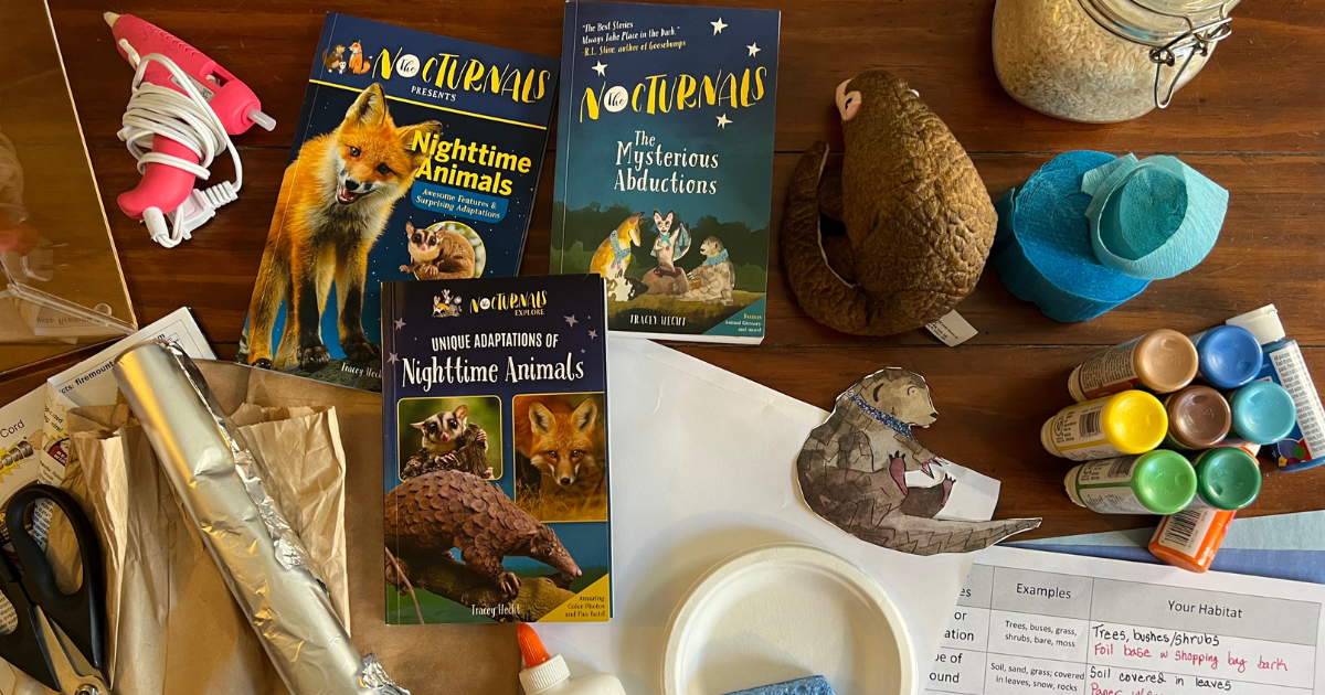 Image shows example craft supplies needed for the activity. From left to right: scissors, glue, aluminum foil, a pink glue gun, 3 Nocturnals books (Nighttime Animals: Amazing Features and Surprising Adaptations,  Unique Adaptations of Nighttime Animals, and The Mysterious Abductions), a stuffed pangolin, different colors of paint.