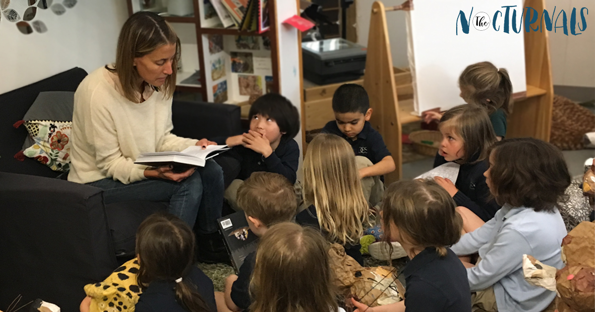 Tracey Hecht, the author of the Nocturnals, is reading to a group of children for World Read Aloud Day. 