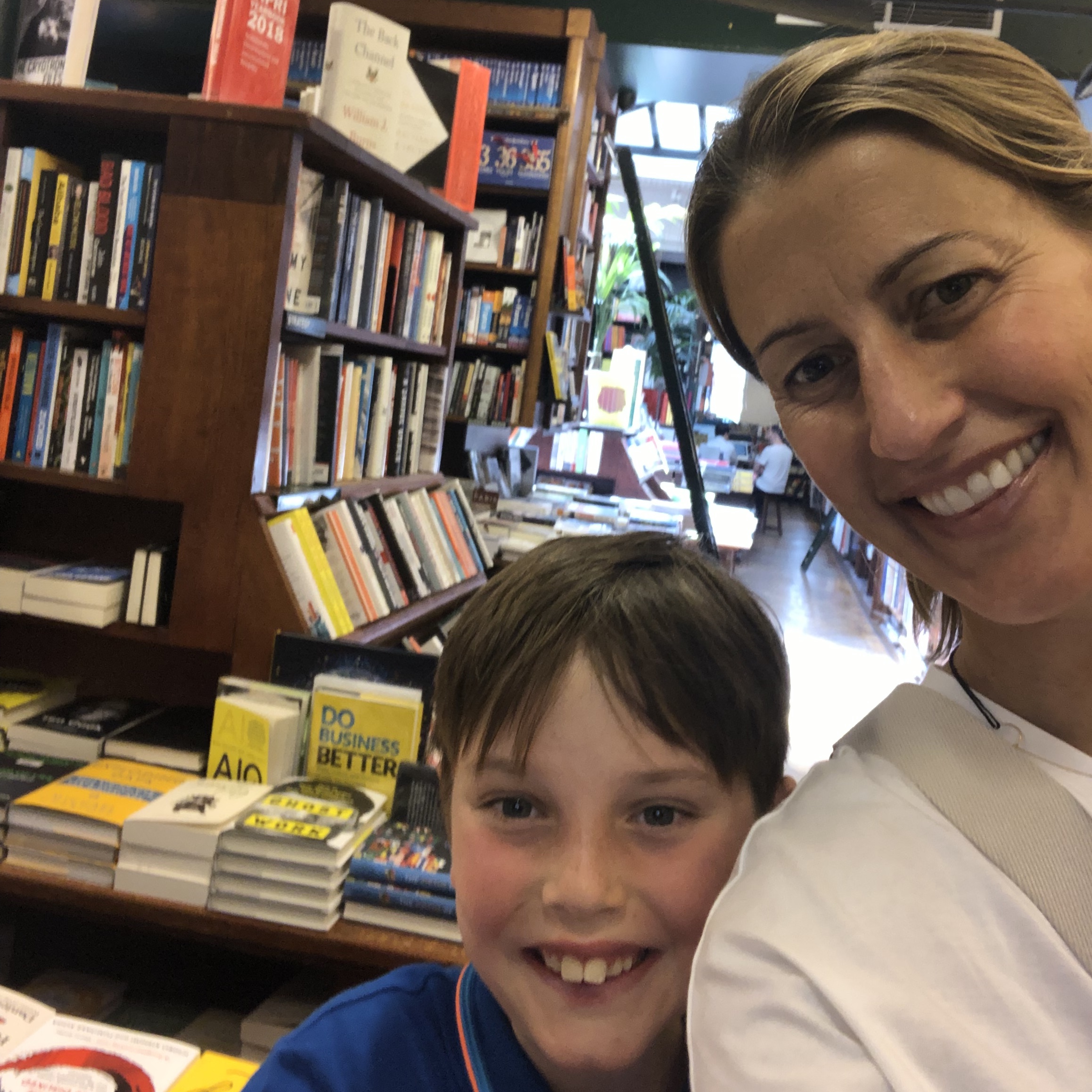 Tracey Hecht, the author of The Nocturnals, is posing with her son in a bookstore. 