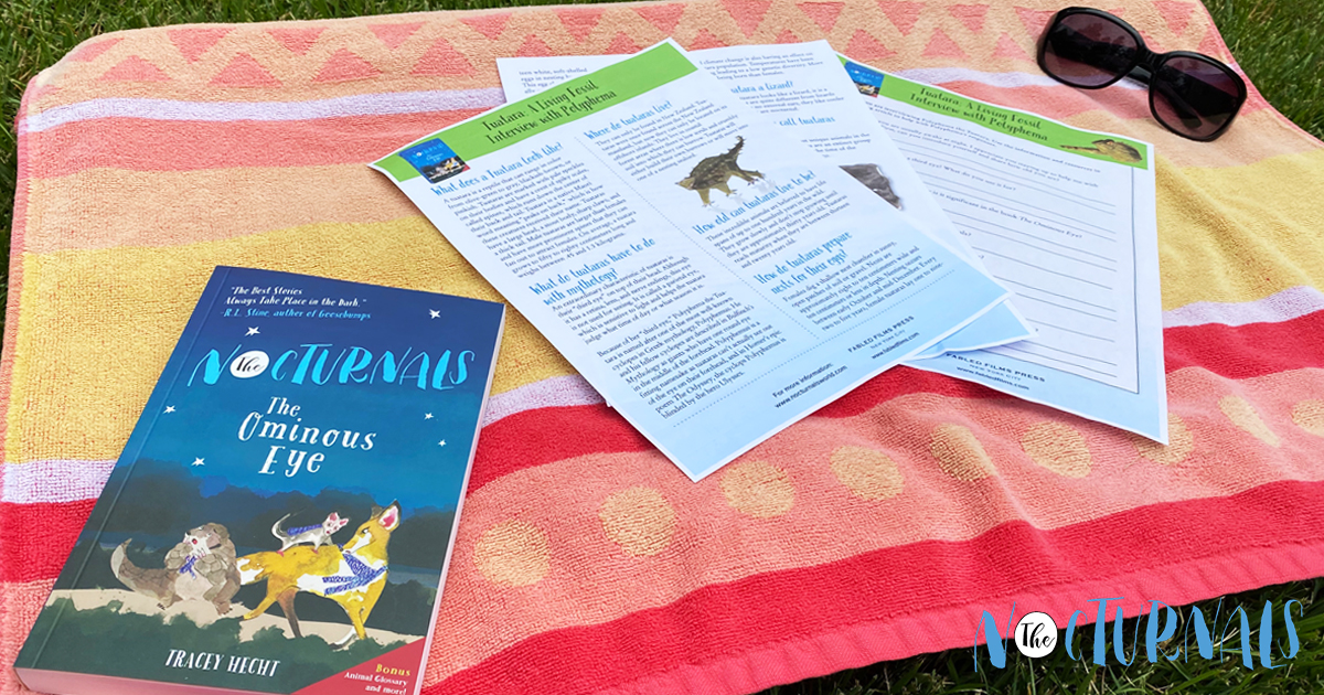 On top of a colorful towel lies a copy of The Nocturnals: The Ominous Eye and a few printouts of the complimentary Summer Reading Worksheets about the mythological dinosaur, a tuatara, featured in the book. A pair of sunglasses is above the worksheets. 