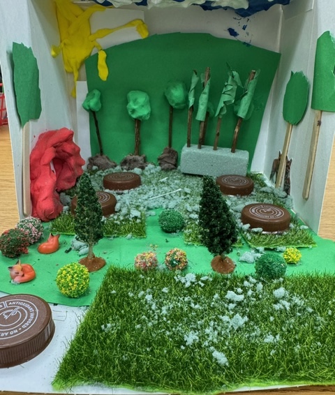 A completed example of the Nocturnals Habitat Activity: a fox diorama made out of paper, cardboard, and other craft supplies.